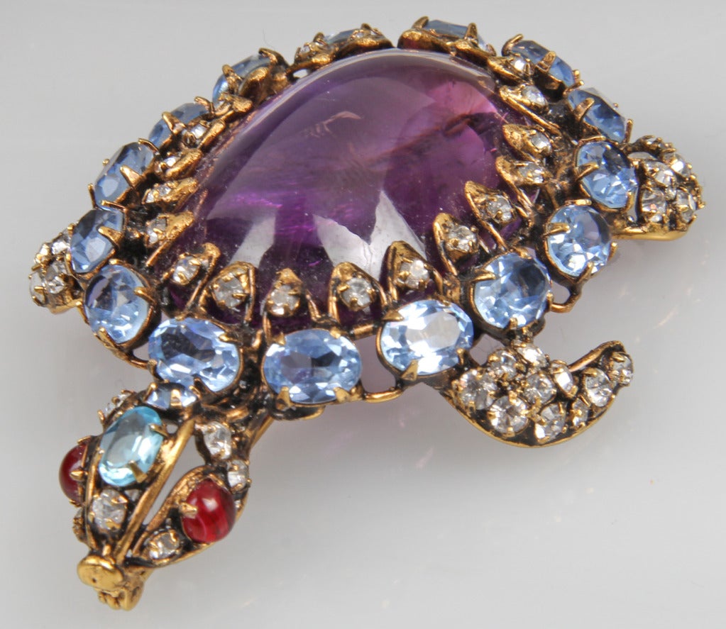 This is beautiful Iradj Moini colored and clear glass rhinestone  encrusted tortoise brooch,  in tones of purple and blue.