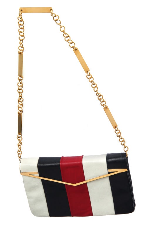 This is a stylish bag with great hardware. We love the 14 inch long chain/strap and gold toned V form on the flap.

9.5 inches wide
7 inches tall
Expandable to 2 inches in depth