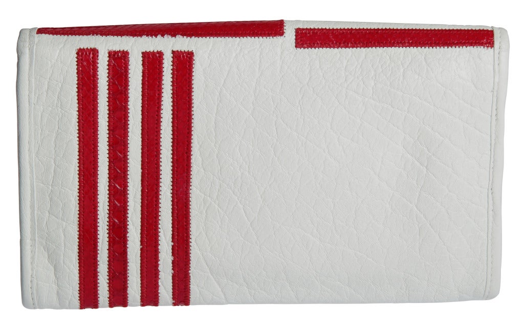 This is a wonderfully designed bag.  We love the juxtaposition of the red lizard  on the white calfskin.  The strap has a  22.50 drop.