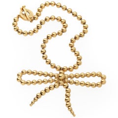 Yves St. Laurent  Gold Toned Bead Necklace with Bow