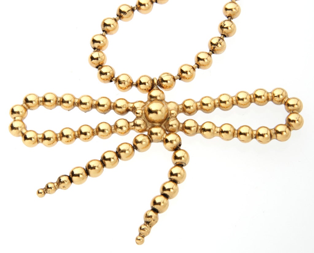 Yves St. Laurent  Gold Toned Bead Necklace with Bow In Excellent Condition In Chicago, IL