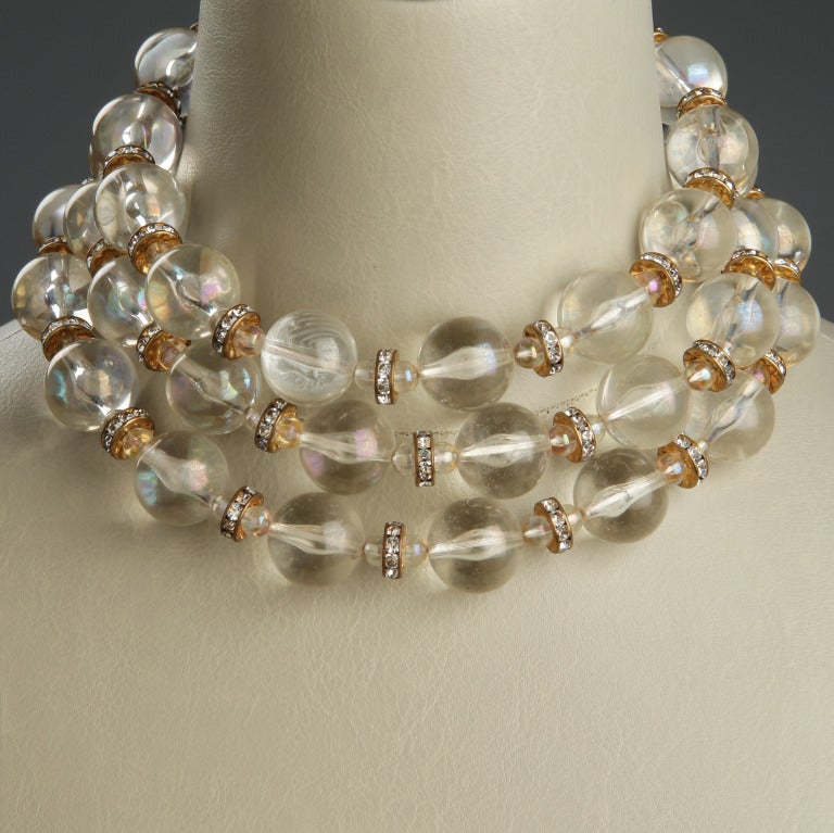 This is a great looking three strand necklace comprised of Lucite Large and small orbs accented by rhinestones roundels.  The necklace is 14 inches long with a 2.75 inch extender.