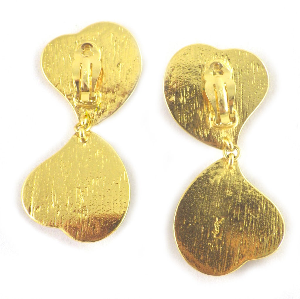 These Yves Saint Laurent red poured glass gold tone earrings are 3 1/8