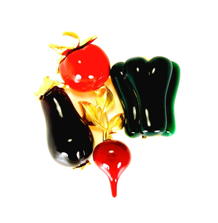 There's ratatouille to be made with the vegetables in this pin. Eggplant, tomato, green pepper and a radish all combine on this rare, stunning  Karl Lagerfeld pin.  

The matte gold, gilt backed pin measures 2 1/2