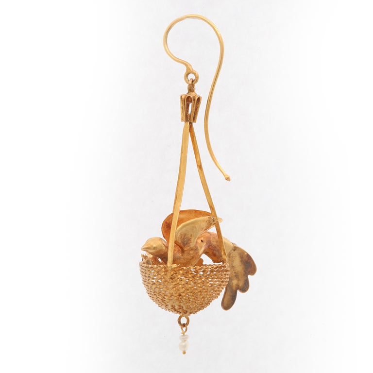 Gold, turquoise, and pearl nesting bird earrings.