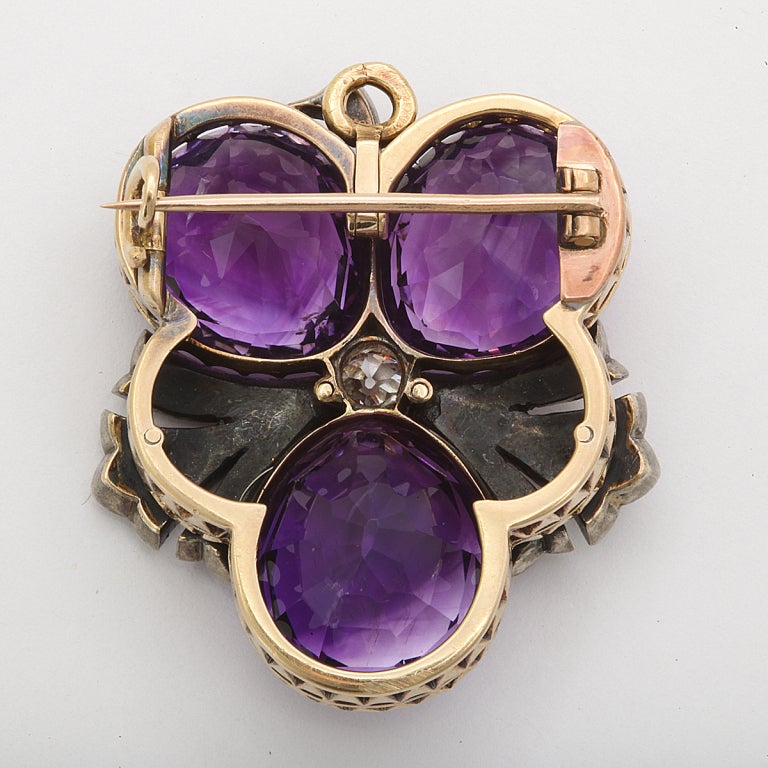 Amethyst and diamond flower brooch, set in gold and silver.
Length: 1-1/2 inches