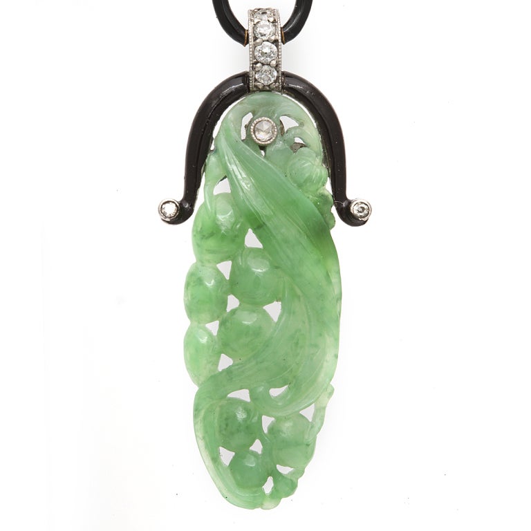 Carved jade, diamond, and enamel pendant earrings.
Length: 2 3/4 inches