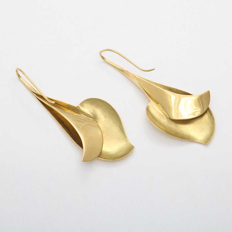 18K gold drop earrings in the form of stylized dolphins.
Length: 2-1/8 inches