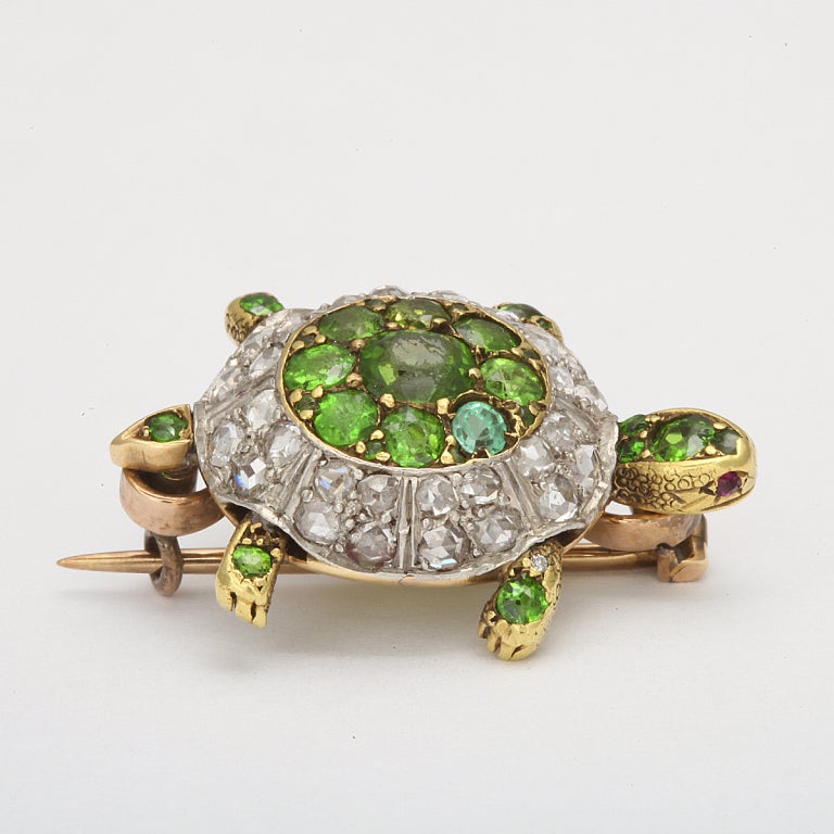 Demantoid garnet and diamond turtle brooch, mounted in gold and silver.