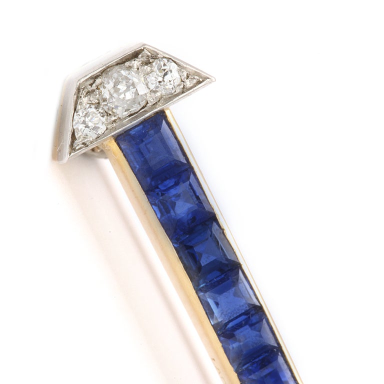 Calibre sapphire and diamond-set brooch in the form of a lucky horse shoe nail, set in platinum and gold. Signed by Lacloche Frères and in original box.