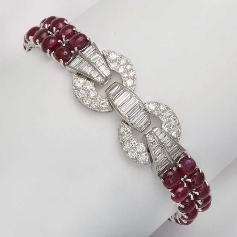 A cabochon ruby and brilliant and baguette diamond bracelet, mounted in platinum. Rubies are approximately 28 cts; diamonds approximately 8.16 cts
