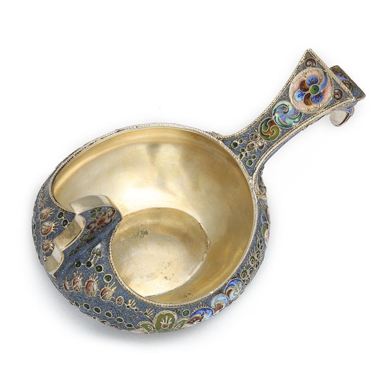 Gilded silver and shaded and cloisonné enamel kovsh with geometric and floral motifs on a blue ground. A kovsh is a traditional Russian drinking cup, originally carved out of wood in the form of a duck. In this decorative kovsh, the bird-like form