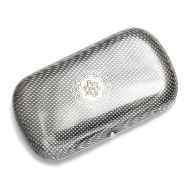 Antique silver and niello cigar case featuring a finely detailed view of the Moscow Kremlin with a checkerboard pattern surround and gilded interior.
5-1/16 x 2-13/16 x 1-1/16 inches