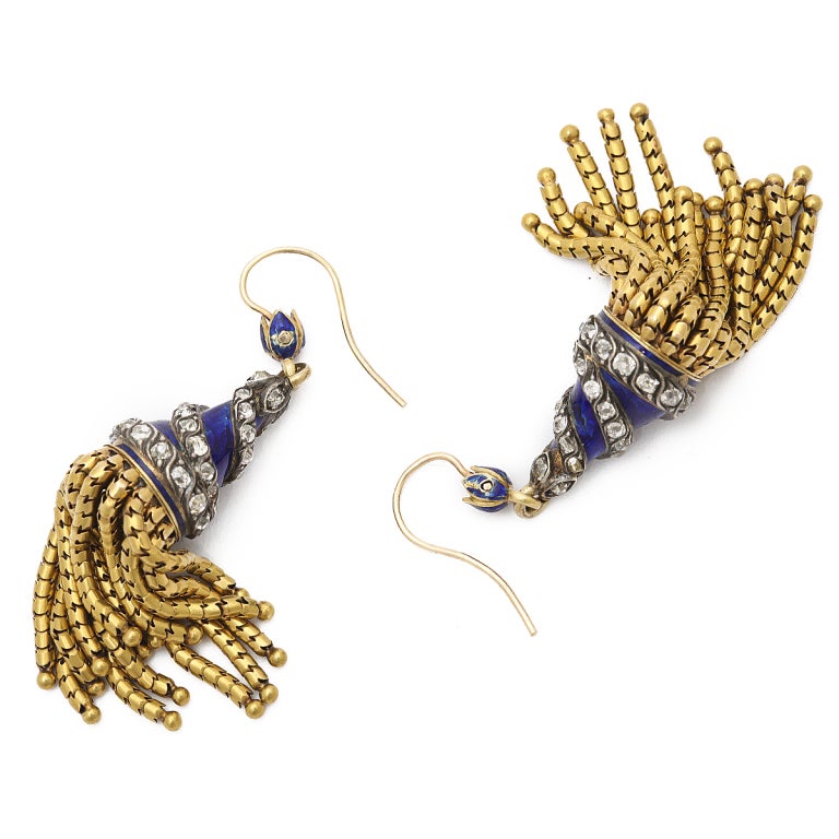 Pair of blue engine-turned enamel earrings ornamented with spiraling diamonds, and fringe of gold tassels.

English, ca. 1870
Length: 2 1/4 inches