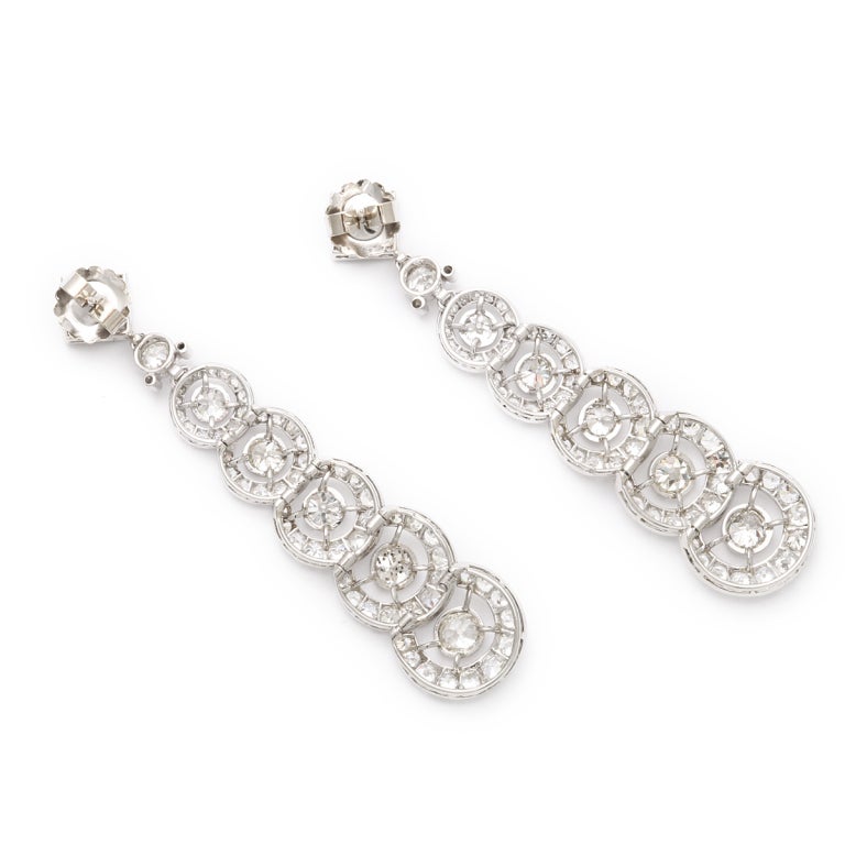 Pair of platinum-set drop earrings composed of overlapping, graduated diamond circles, each featuring a center diamond. Approximately 14 carats total. 

By Henri Picq
Length: 3 inches