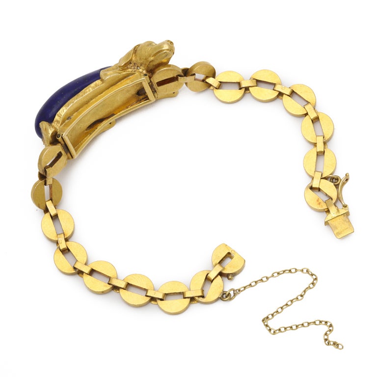 Gold link bracelet adorned with a dachshund composed of lapis lazuli and gold, with diamond eyes.