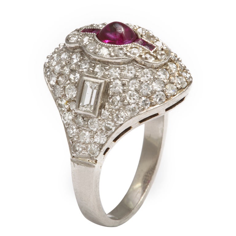 Mixed cut pavé diamond bombé ring with cabochon ruby in center, set in platinum.