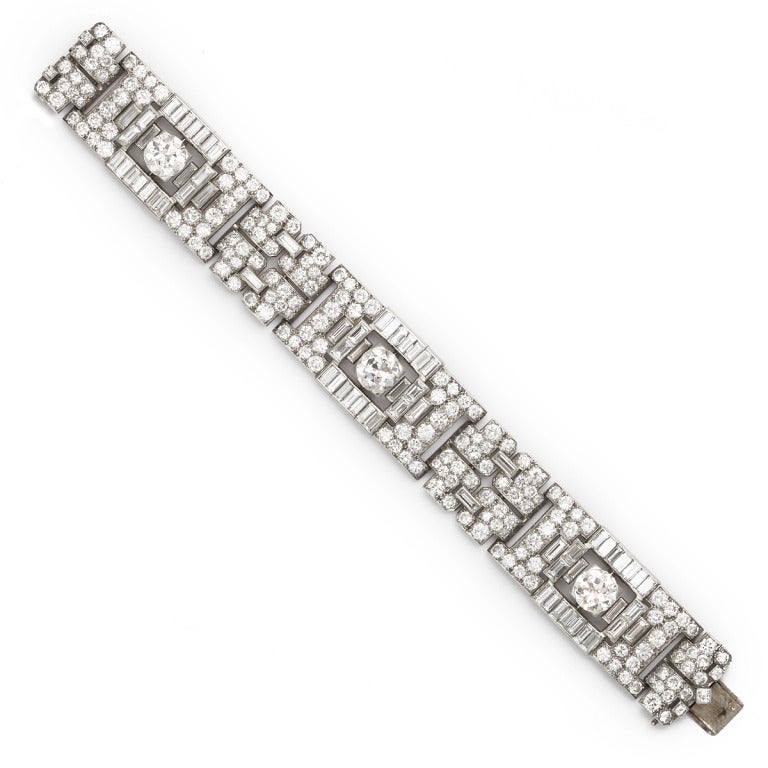 Art Deco platinum-set bracelet composed of cushion-, brilliant-, and emerald-cut diamonds. By Boucheron, Paris.

247 diamonds. Center round diamonds are approximately 2.5 cts each. Approximately 45.25 cts total.