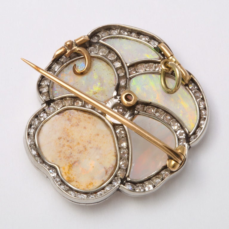 Opal pansy brooch mounted in platinum with petals bordered by diamonds.