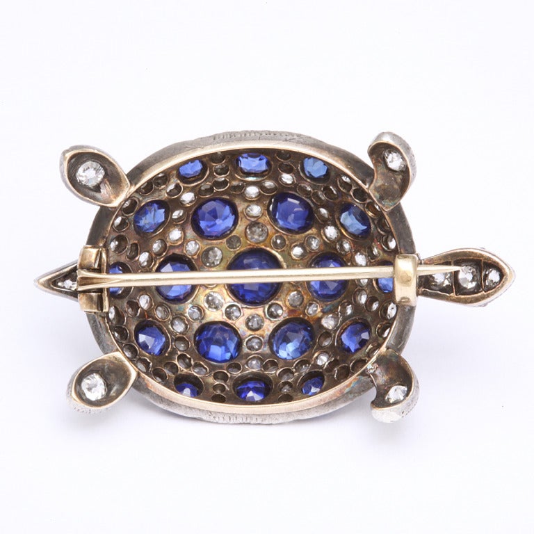 PavÃ??Ã?© sapphire and old-mine diamond turtle brooch set in gold topped silver with cabochon ruby eyes.