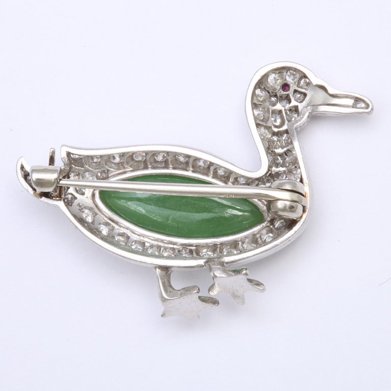 Pavé diamond duck brooch with a ruby eye and a cabochon chrysoprase central wing, mounted in platinum.