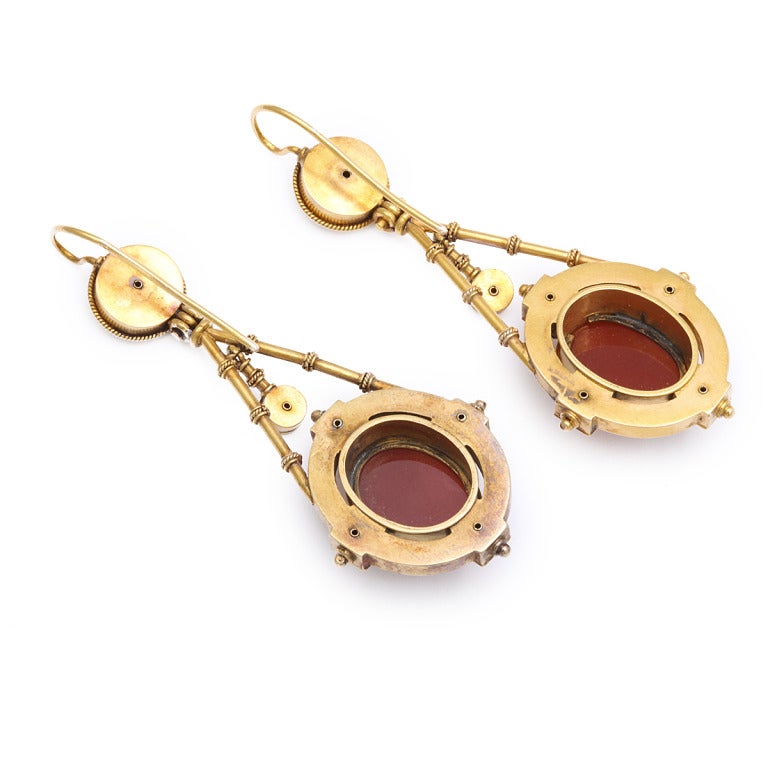 Roman Revival pendant earrings with hardstone agate cameos of ladies in profile with filigree and granulation in 15k gold. 

The small, low relief sculptures we recognize as cameos date to antiquity, used in Classical Greece and Rome to depict