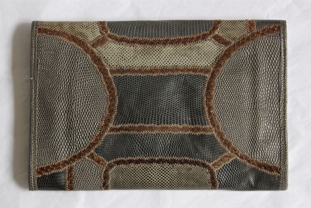 Beautiful grey and brown patchwork clutch made of reptile skins from Carlos Falchi. Bag measures approximately 12