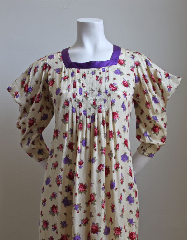 Gorgeous silk brocade floral dress with pintucking at front and back form Emanuel Ungaro Parallele dating to the early 1980's. Purple satin ribbon trim at neckline. Hidden pockets at hips. Size 4. Dress measures 40