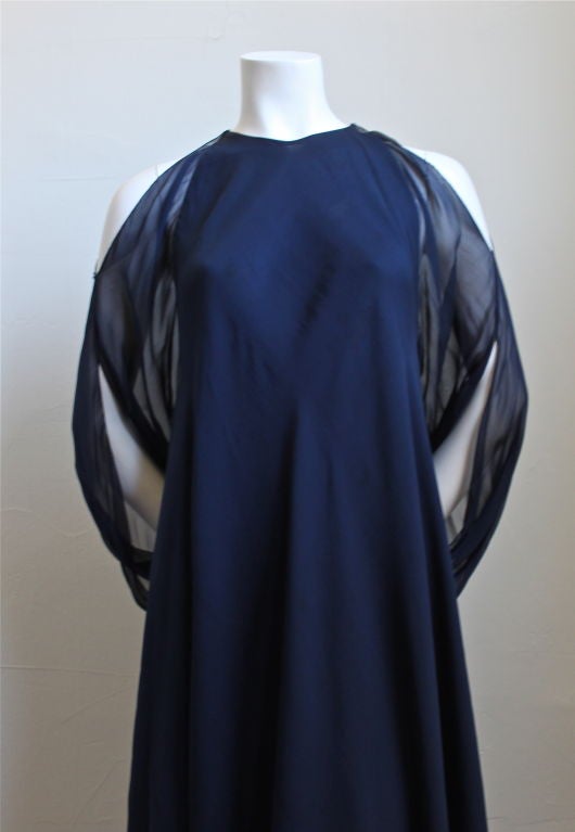 Navy blue silk chiffon dress with cut out shoulders and amazing billowy arms from Halston dating to the 1970's. Sizing is very flexible due to the loose cut. Dress fits a US 4-10. Slips on over the head and secures with a hook and eye on each side
