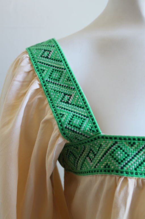 Billowy cream peasant blouse with vibrant green woven trim from Yves Saint Laurent dating to the 1970's. Fits a US size 4-8. Band above bust measures 36