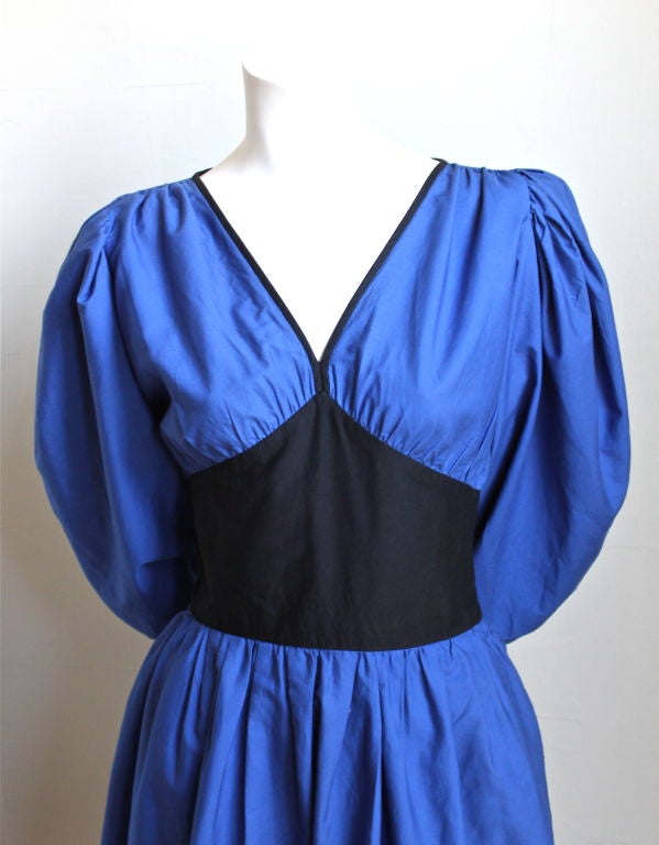 Beautiful vivid blue cotton poplin dress with black waist accent and large billowy arms from Yves Saint Laurent dating to the early 1980s. French size 40, yet fits a US 2 or 4 (smaller ribcage). Side zip. Unlined. Made in France. Excellent condition.