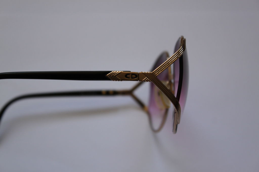 Oversized gilt metal sunglasses with purple gradient lenses from Christian Dior dating to the 1980's. Made in Germany. Excellent condition with new lenses. Original case is included.