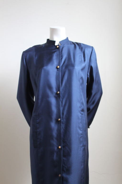 Rich blue long silk jacket with lion buttons from Chanel dating to the 1970's. Fits a size 6-10. Fully lined. Padded shoulders. Pockets at hips. Made in France. Excellent condition.