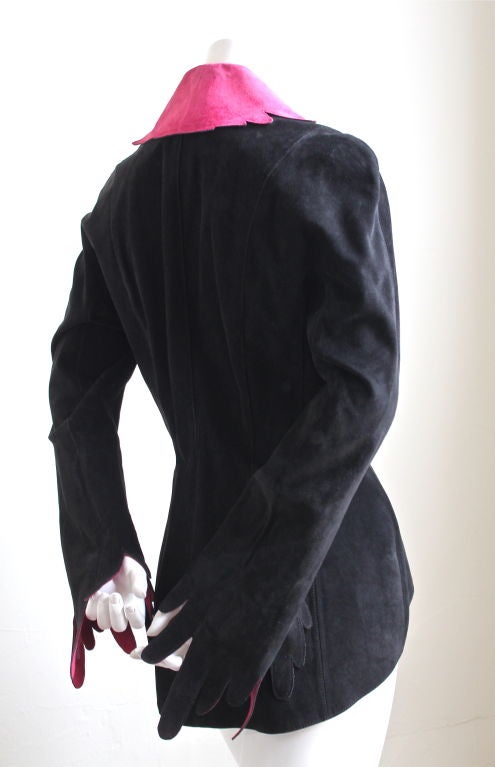 Jet black suede sculptured jacket with unique red (slightly pink) suede collar and cuffs. Fits a US 4-8. Fully lined. Triple snap closure. Fully lined. Made in France. Excellent condition.