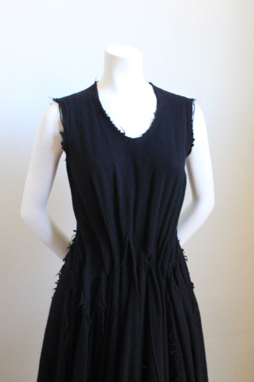 Black Victorian 'tattered' wool dress with pleats from Junya Watanabe by Comme des Garcons dating to winter 2002. Size 'S'. The bust measures approximately 34