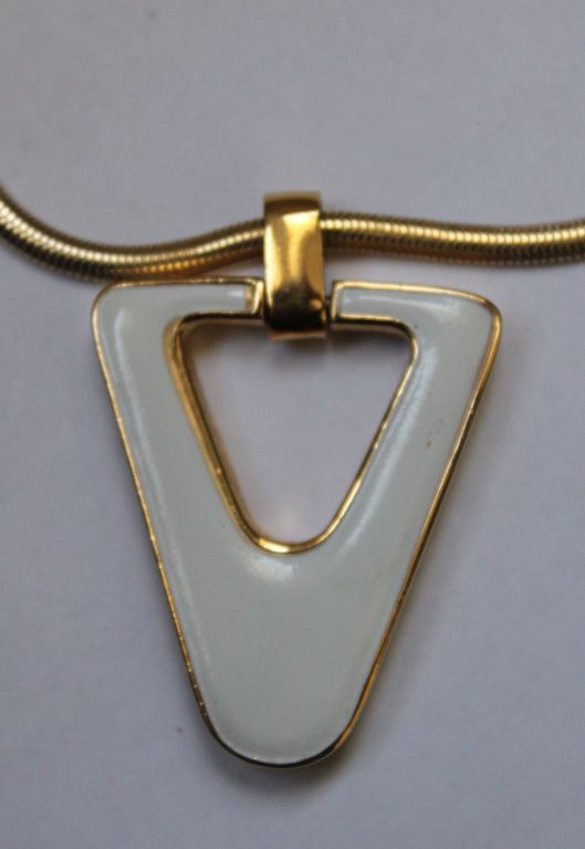 Oversized geometric enameled necklace in gilt metal designed by Lanvin dating to the 1970's. The approximate measurements for the pendant is just under 3” long with bail by about 2” at widest and chain is just over 18