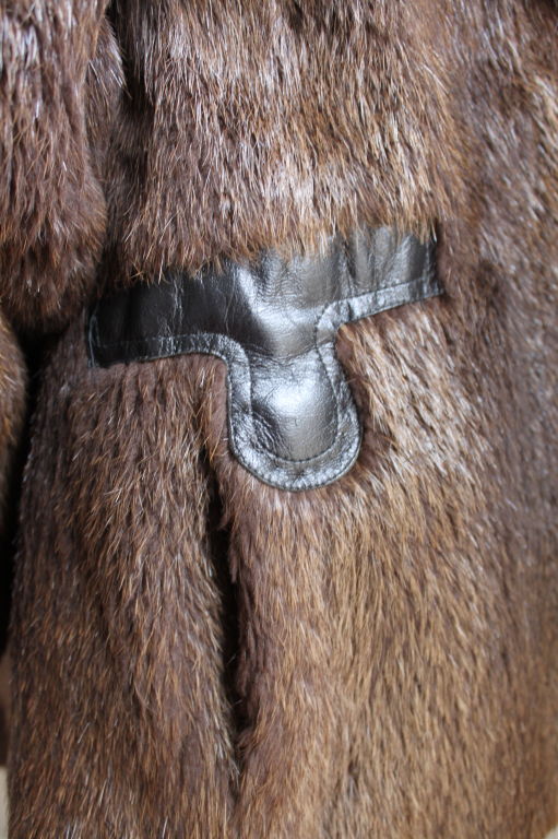 Deep chocolate brown beaver fur with fox collar and geometrically shaped leather trim from Pierre Cardin dating to the late 1960's. Fits a US 4 to 6. Double hook closure. Fully lined. Pockets at hips. Very good condition.
