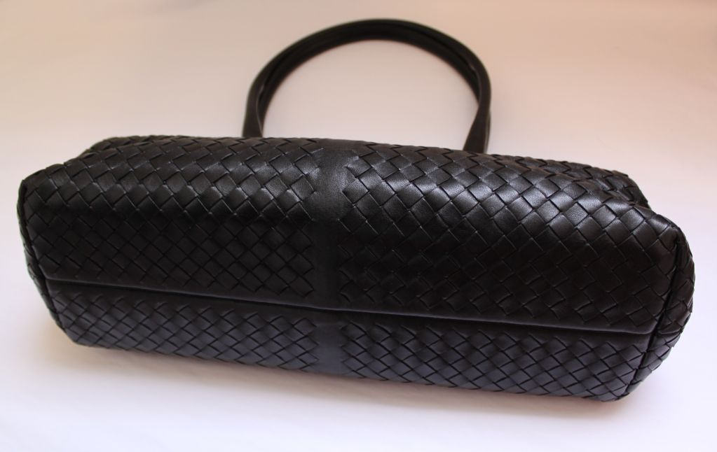 Classic jet black woven leather doctor bag from Bottega Veneta. Bag measures 8