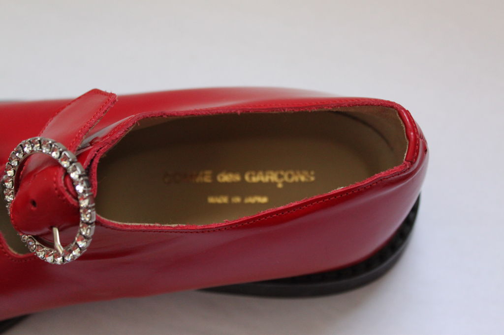 Very rare red leather shoes with rhinestone buckles from Comme des garcons. Sized a JP 26/ US 10 but may fit up to a narrow US 10.5 or 11. Flat with non slip soles. The shoes are NEW and are in EXCELLENT CONDITION.