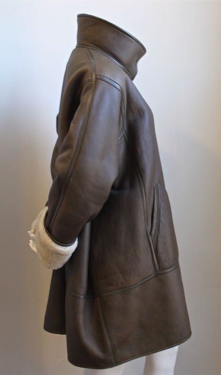 Uniquely cut brown shearling coat from Kenzo dating to the 1980's. Labeled a size '38' although fits many sizes due to oversized cut. Snap closure. Pockets at hips. Made in France. Very good condition.