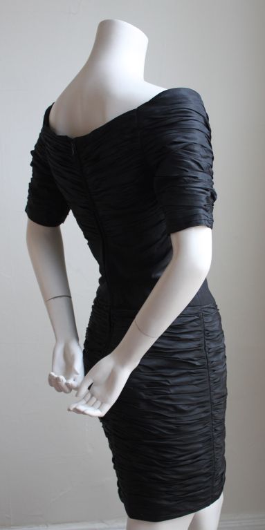 Jet black ruched mini dress from Loris Azzaro dating to the 1980's. Dress best fits a US size 2 (32