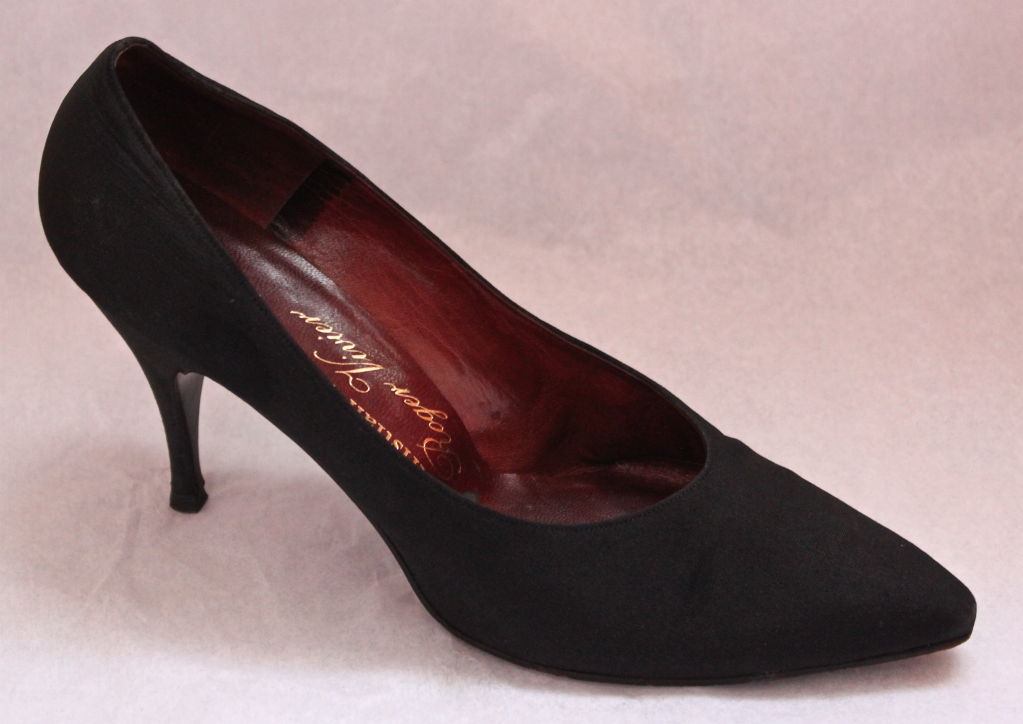 Jet black fabric stiletto heels from Christian Dior made by Roger Vivier dating to the 1950's. Labeled a size 7.5. Fully lined in leather with leather soles. Made in France. Very good condition.