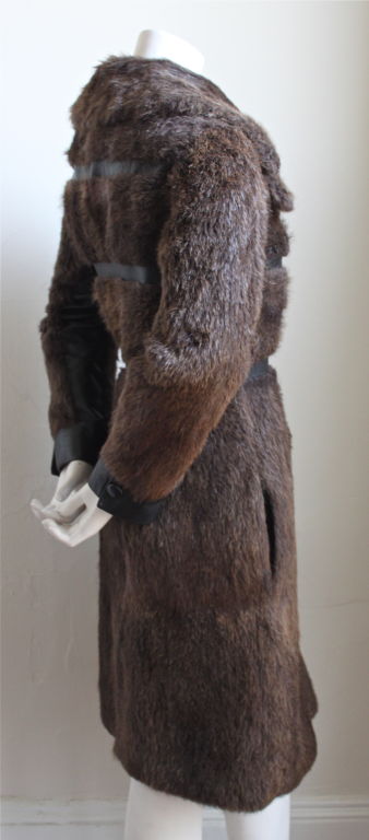 Streamlined brown beaver fur coat with leather insets from Emanuel Ungaro dating to the 1970's. Fits a size 4-6. Fully lined. Pockets at hips. Made in France. Very good condition.