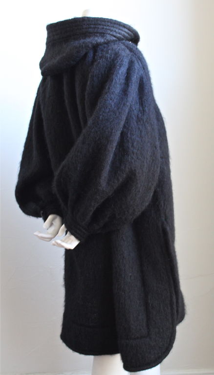 Jet black fuzzy mohair hooded coat with toggle buttons from Yves Saint Laurent dating to the 1980's. Coat is labeled a French size 38 and fits a size 4-10 due to loose oversized cut. 36