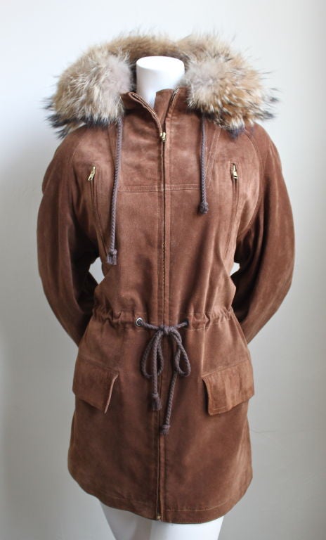Sienna suede parka with raccoon fur trimmed hood from Hermes dating to the 1970's. French size 38, which best fits a US 4 or 6. 33
