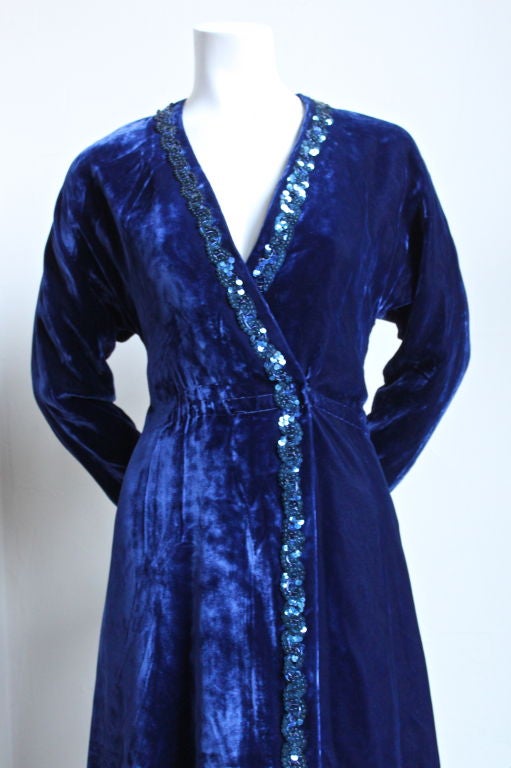 Royal blue crushed velvet wrap dress with sequined trim from Halston dating to the late 1970's. Fits a size 6 or 8. Fully lined. Secures with hooks. Made in the U.S. Very good condition.