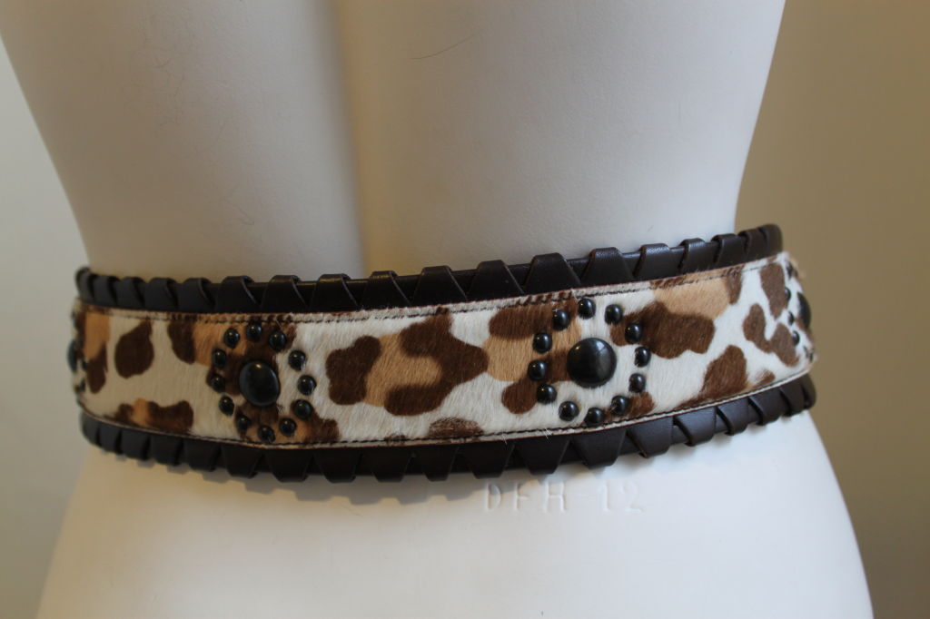 Gorgeous leopard printed calf hair belt with studded detail and buckle closure from Azzedine Alaia. Brown, tan and off white in color. Brown leather trim and darkened hardware. French size 80. Made in Italy. Excellent unworn condition with original