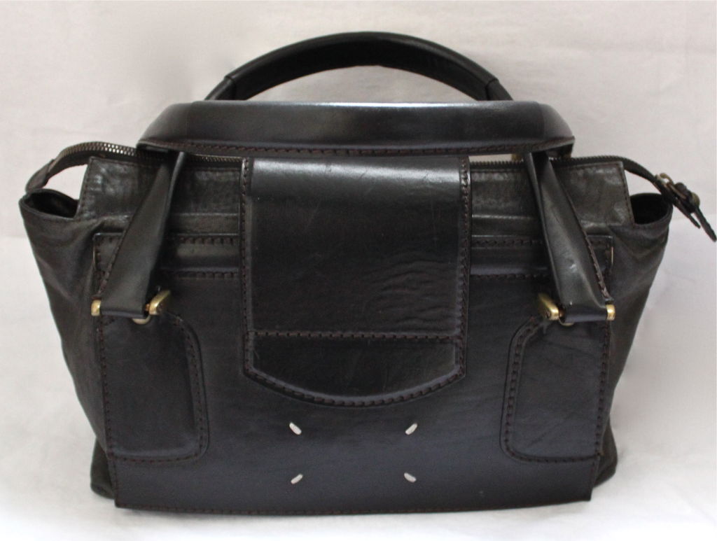 Deepest brown and black distressed satchel bag from Martin Margiela. Bag measures approximately 13