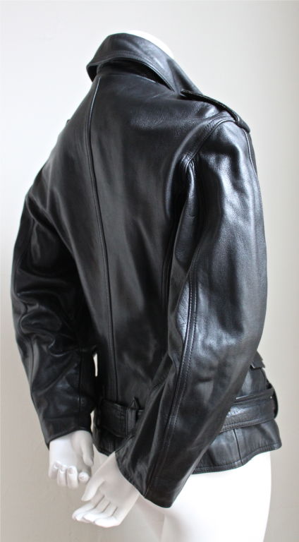 Jet black leather motorcycle jacket with fitted waist from Jean Paul Gaultier junior dating to the 1990's. Labeled a size 42, which best fits a US 4 or 6. Jacket measures 36