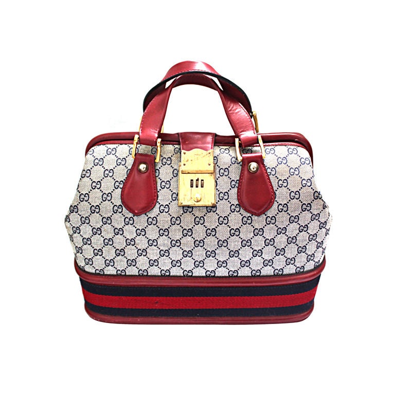 GUCCI monogrammed canvas and red leather travel bag at 1stDibs